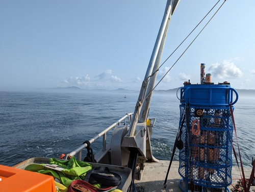 An image of an ocean profiler looking back on the Oregon coast from the back of a boat